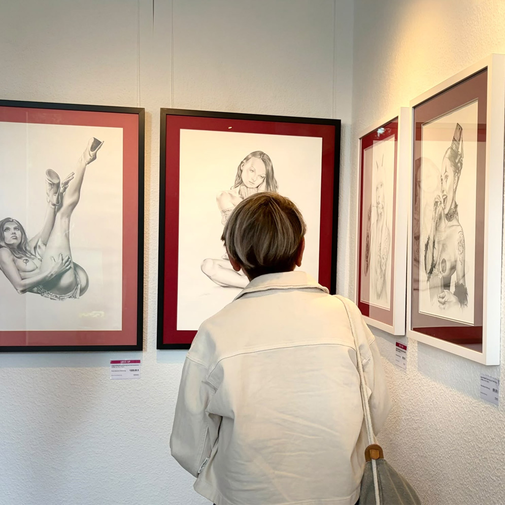 Besucher betrachten Bleistiftzeichnungen bei der Ausstellung Stars & Stripes in Bochum